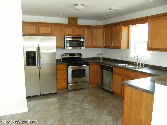 Lot 23 Legion Road Kunkletown, PA 18058 - Photo 4 of 14 a kitchen with stainless steel appliances granite countertop a stove a sink and a microwave