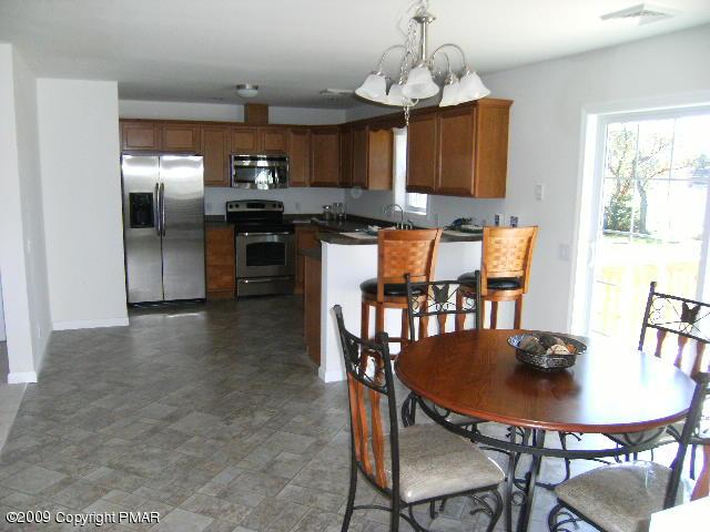 Lot 23 Legion Road Kunkletown, PA 18058 - Photo 6 of 14 a kitchen with stainless steel appliances granite countertop a dining table chairs and granite counter tops