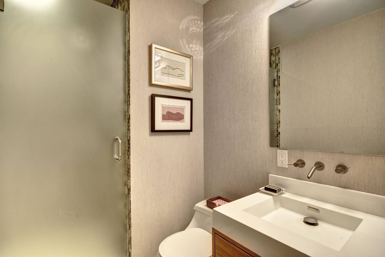 18 Glover Street Sag Harbor, NY 11963 - Photo 17 of 26 a bathroom with a sink mirror and toilet