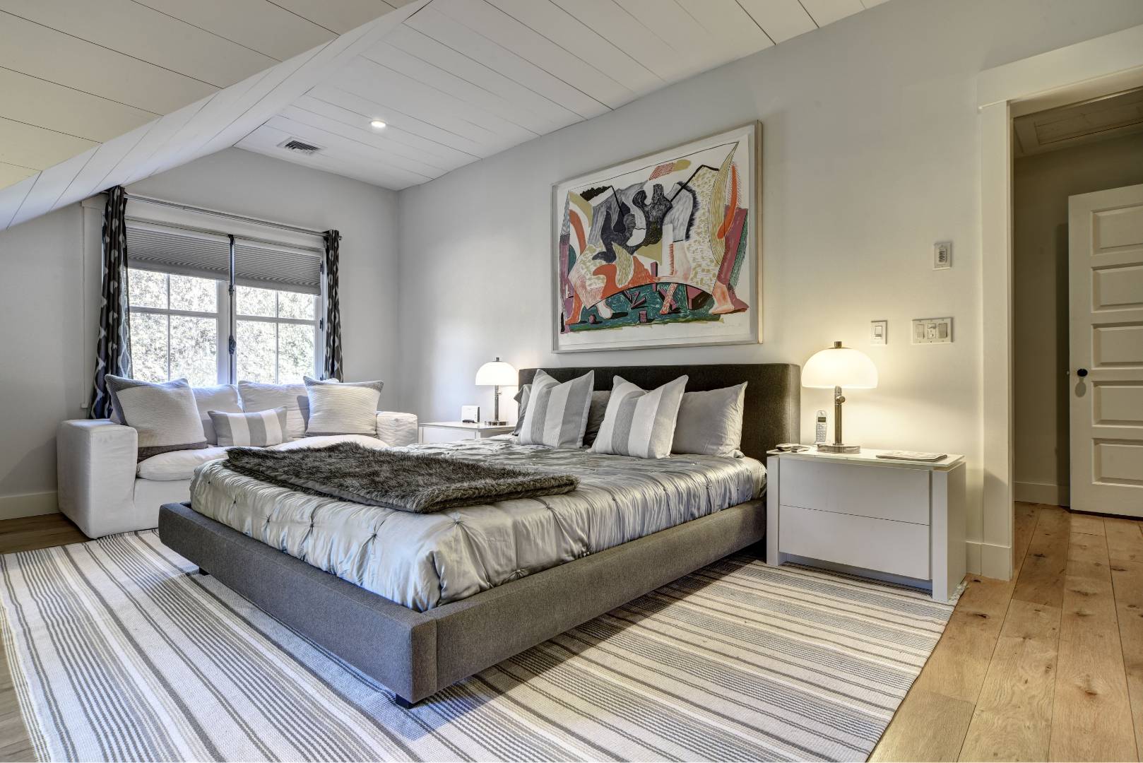 18 Glover Street Sag Harbor, NY 11963 - Photo 18 of 26 a bedroom with a bed and glass windows