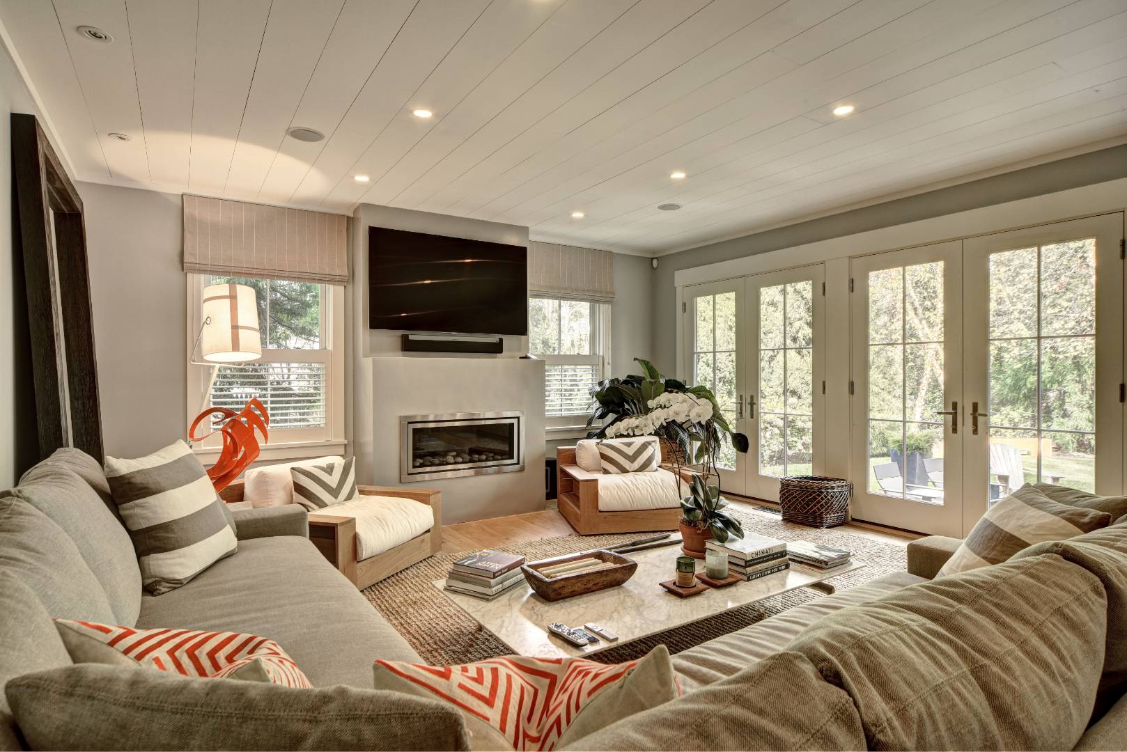 18 Glover Street Sag Harbor, NY 11963 - Photo 9 of 26 a living room with furniture a flat screen tv and a large window