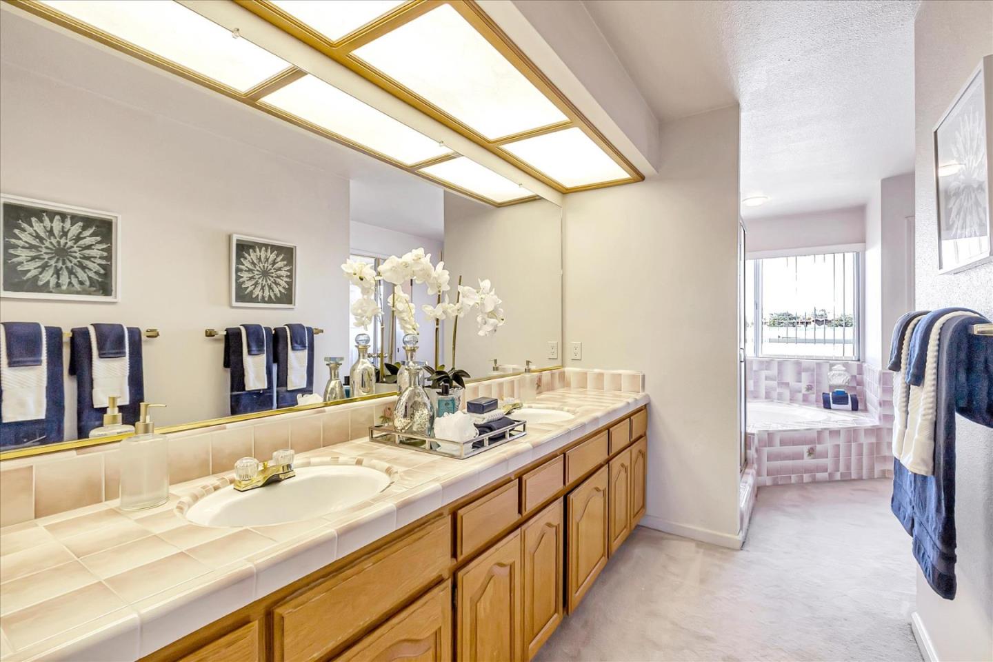 18809 Cabernet Drive Saratoga, CA 95070 - Photo 19 of 29 a spacious bathroom with a double vanity sink and a mirror