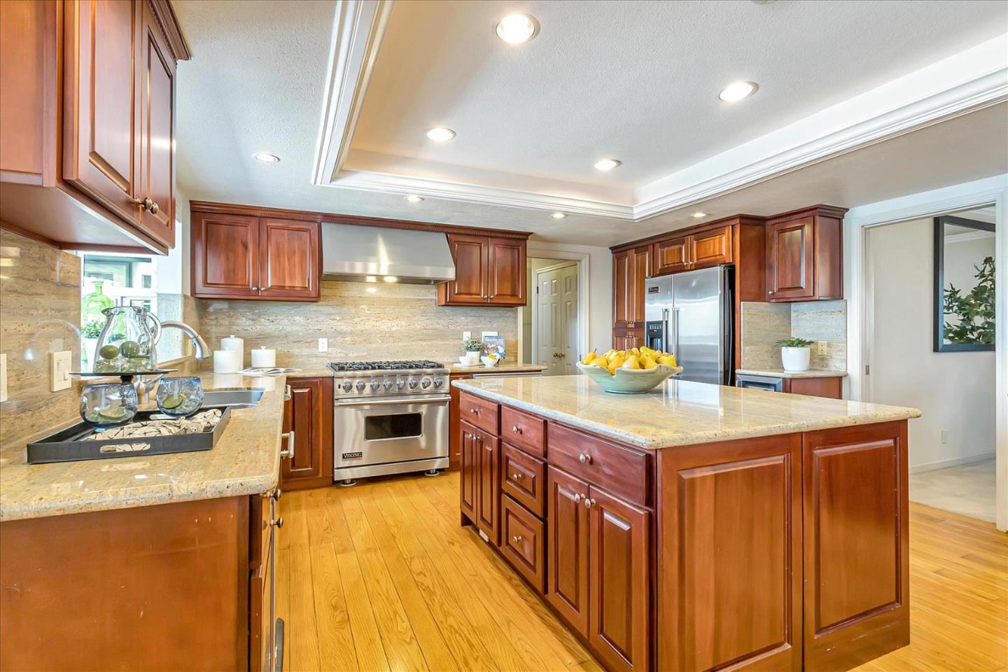 18809 Cabernet Drive Saratoga, CA 95070 - Photo 6 of 29 a kitchen with stainless steel appliances granite countertop a stove a sink and a microwave