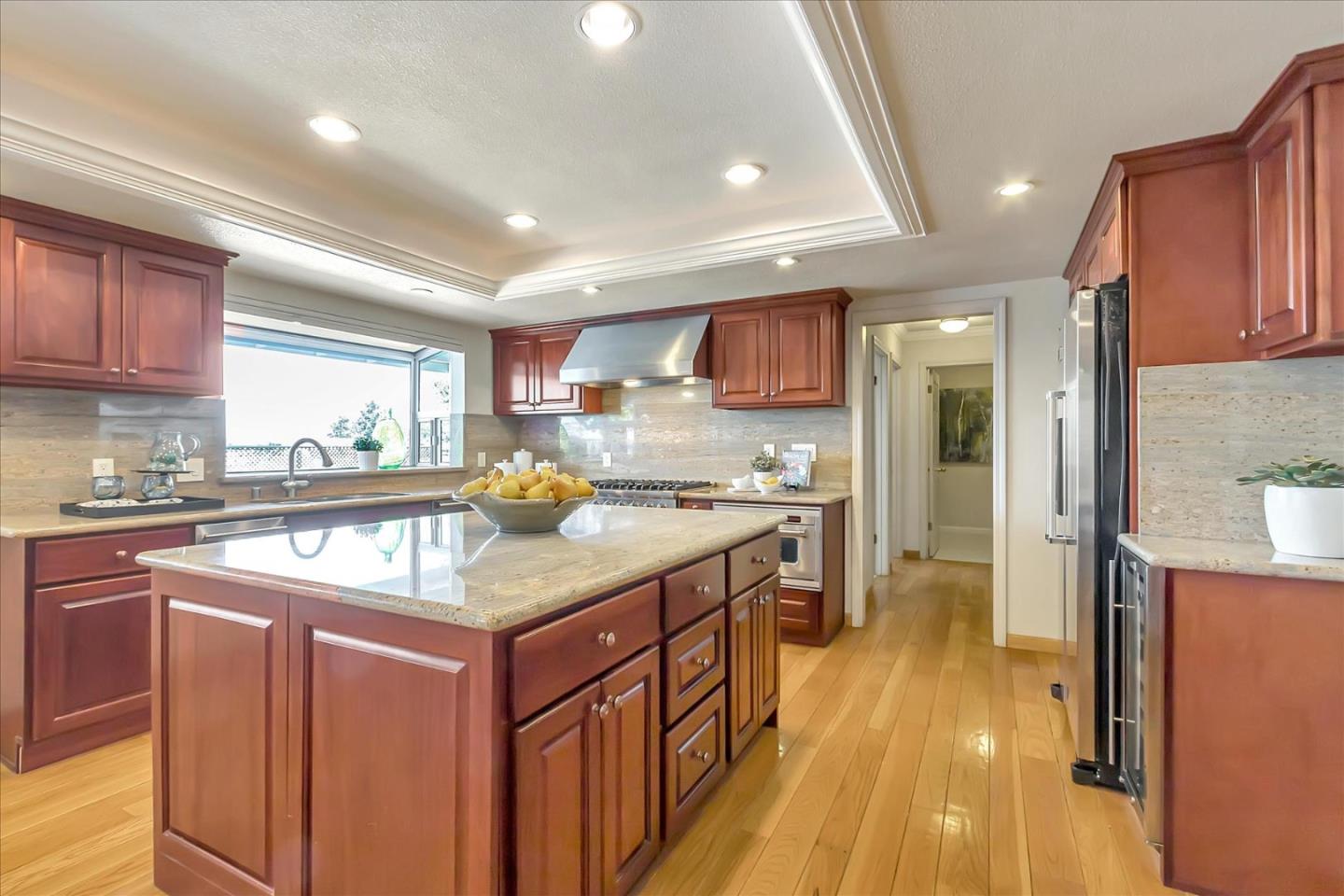 18809 Cabernet Drive Saratoga, CA 95070 - Photo 7 of 29 a kitchen with stainless steel appliances granite countertop a kitchen island a stove a sink a refrigerator and cabinets