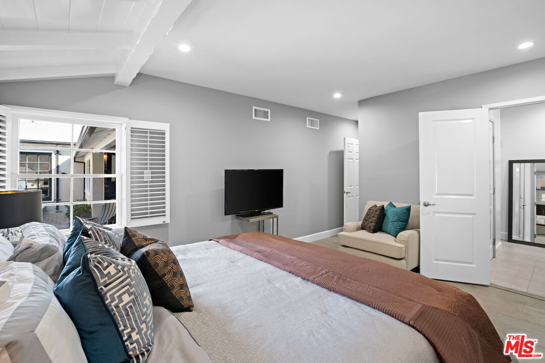3733 Wrightwood Drive Studio City, CA 91604 - Photo 16 of 49 a bedroom with a bed and a flat screen tv