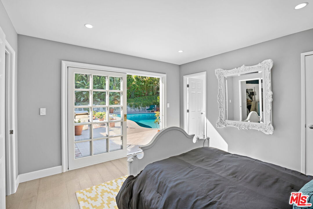 3733 Wrightwood Drive Studio City, CA 91604 - Photo 25 of 49 a bedroom with a bed and glass door