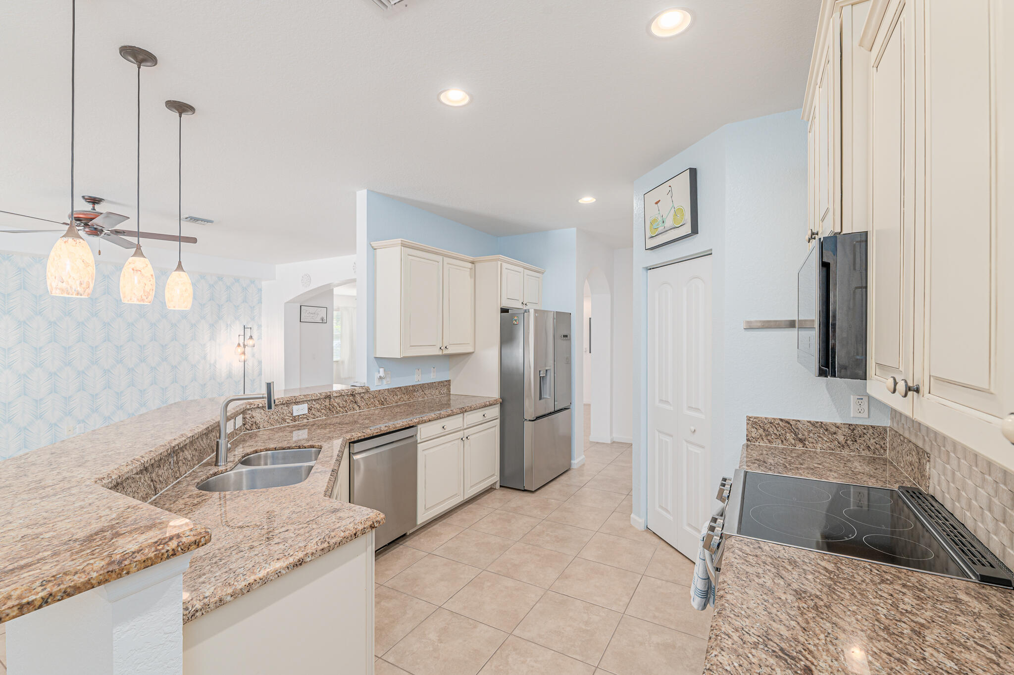 2187 Northwest Dalea Way Stuart, FL 34994 - Photo 16 of 41 a kitchen with a sink stove and refrigerator