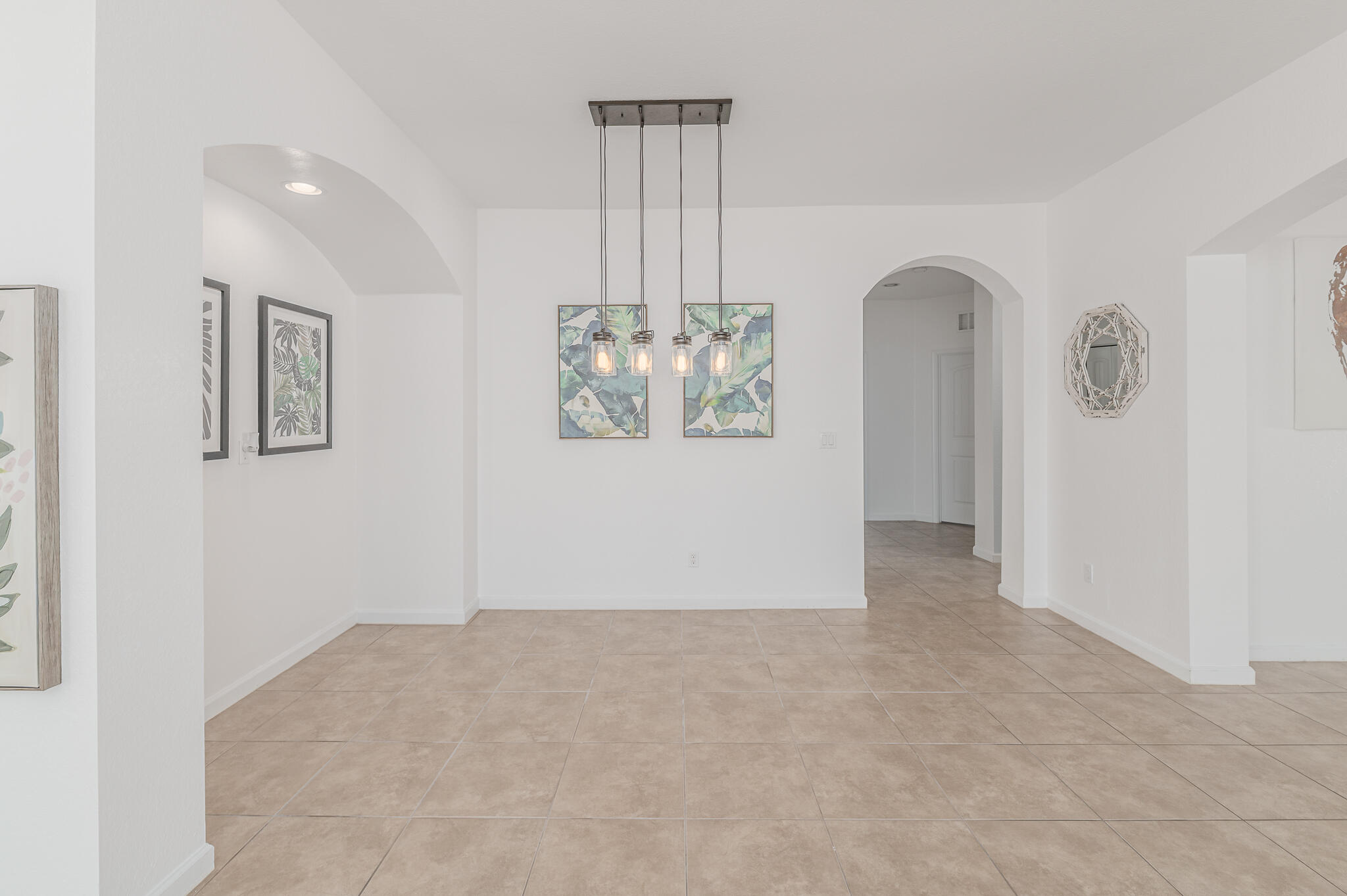 2187 Northwest Dalea Way Stuart, FL 34994 - Photo 19 of 41 an empty room with windows and chandelier