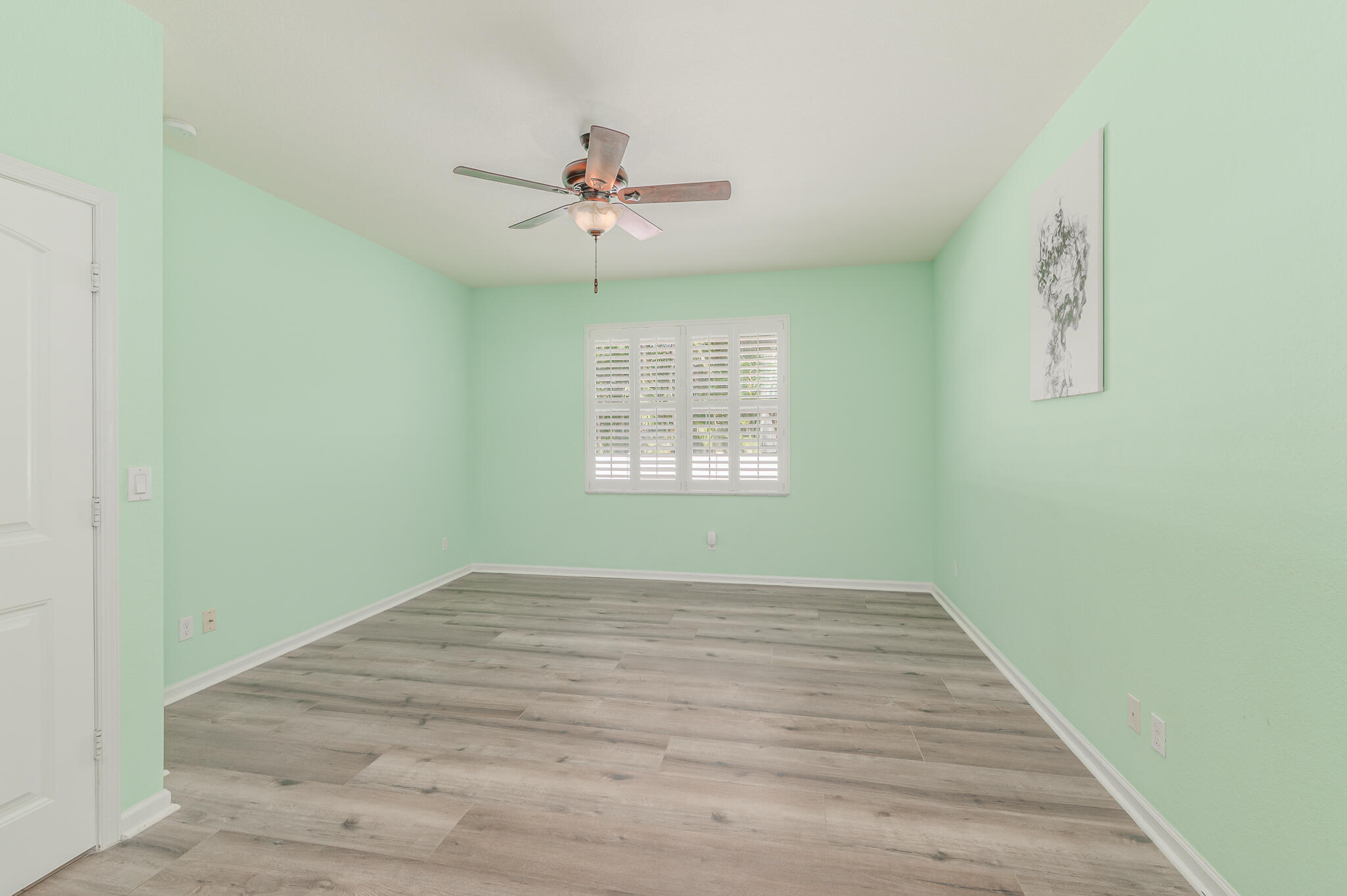 2187 Northwest Dalea Way Stuart, FL 34994 - Photo 21 of 41 an empty room with windows and fan