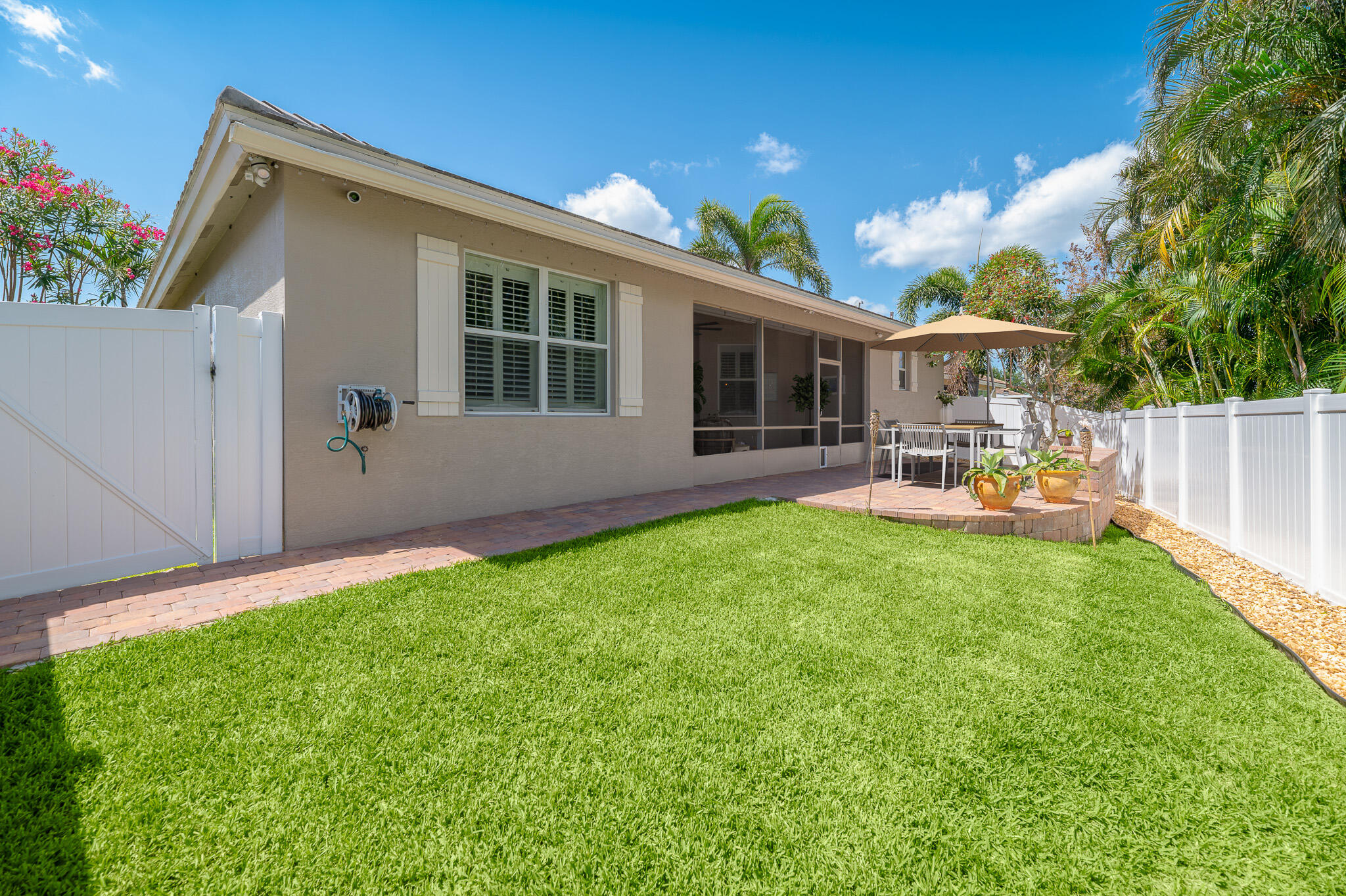 2187 Northwest Dalea Way Stuart, FL 34994 - Photo 29 of 41 a view of backyard of house with outdoor seating and green space