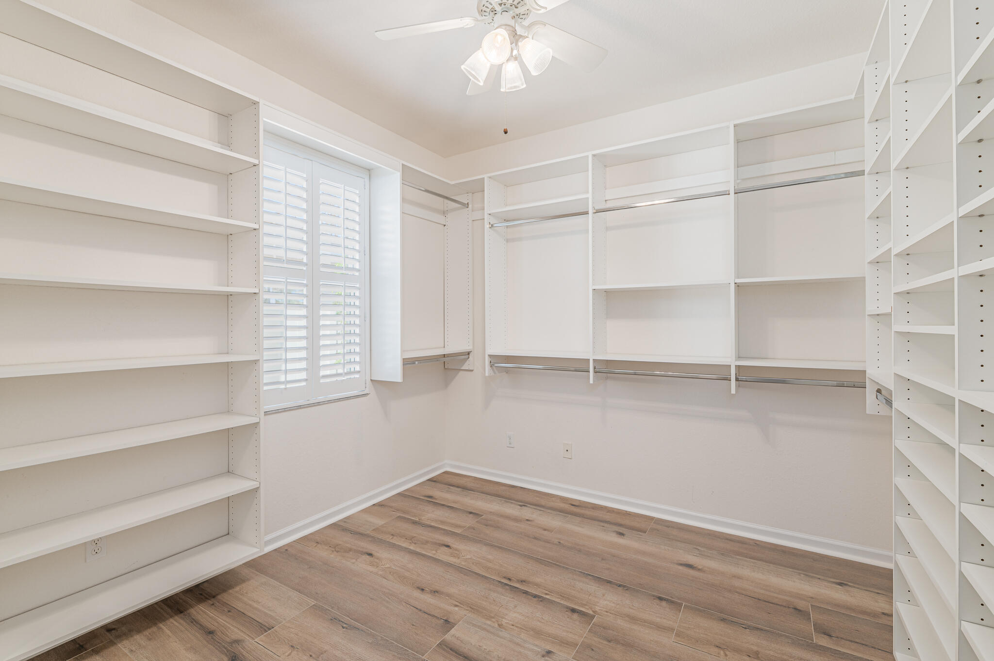 2187 Northwest Dalea Way Stuart, FL 34994 - Photo 31 of 41 a view of walk in closet with empty racks