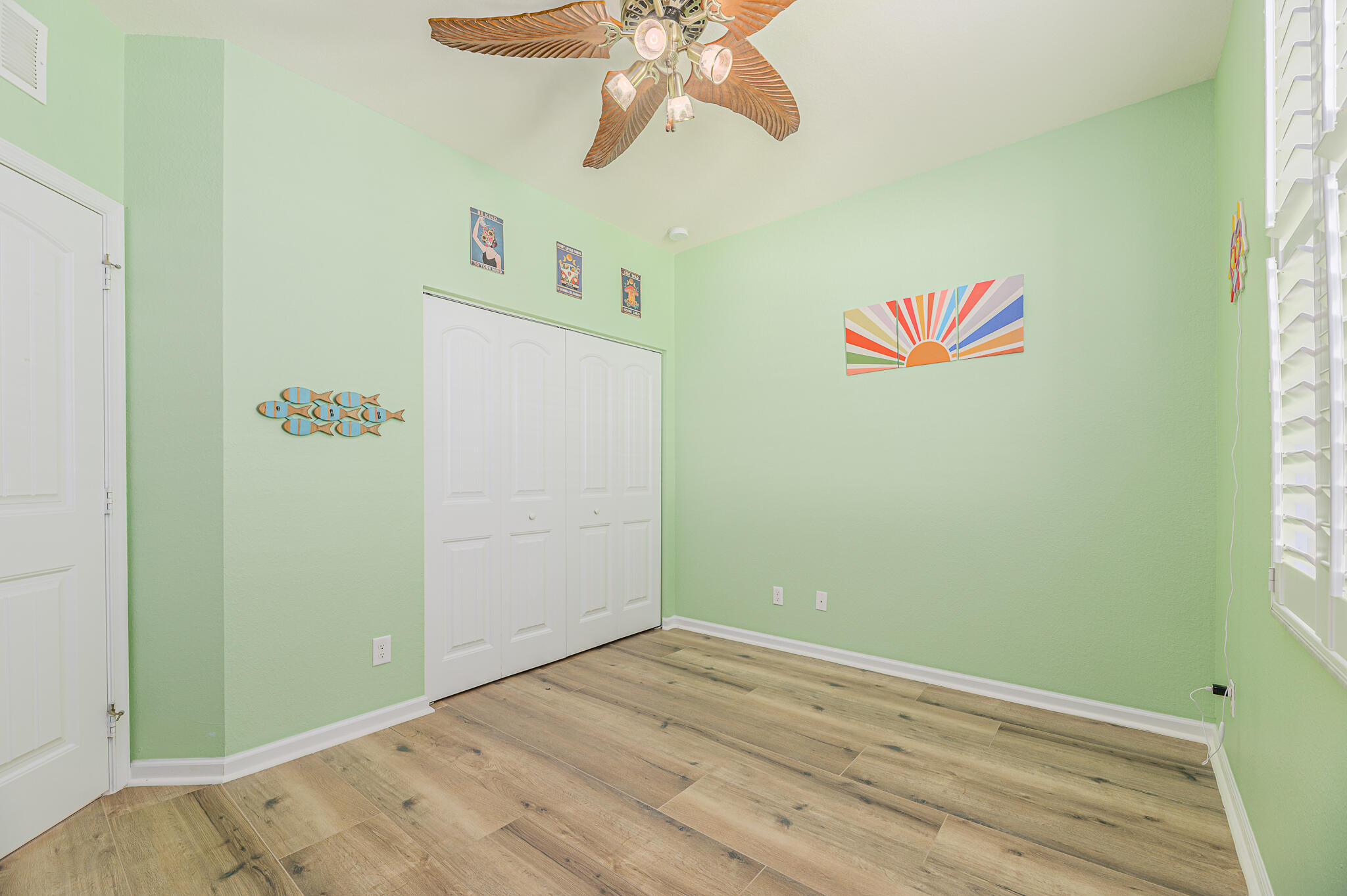 2187 Northwest Dalea Way Stuart, FL 34994 - Photo 33 of 41 an empty room with a window and a ceiling fan