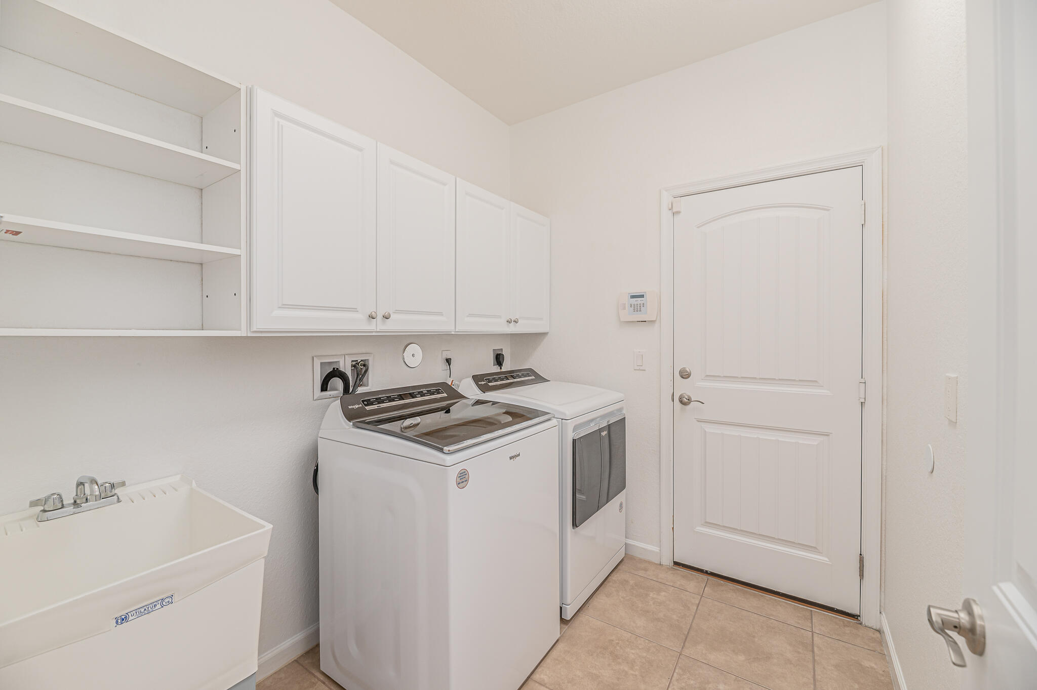 2187 Northwest Dalea Way Stuart, FL 34994 - Photo 34 of 41 a utility room with sink dryer and washer