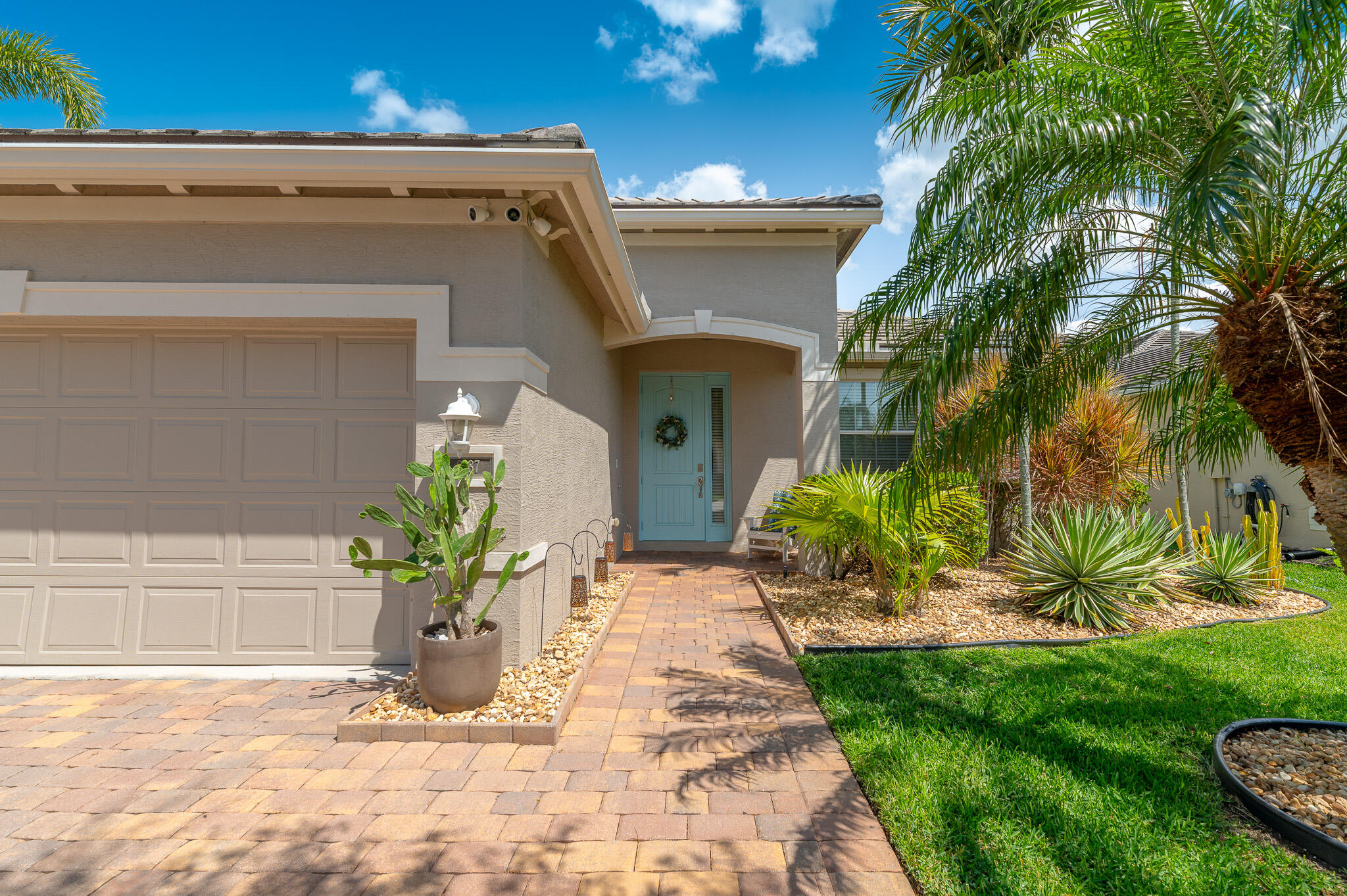 2187 Northwest Dalea Way Stuart, FL 34994 - Photo 4 of 41 a front view of a house with a yard