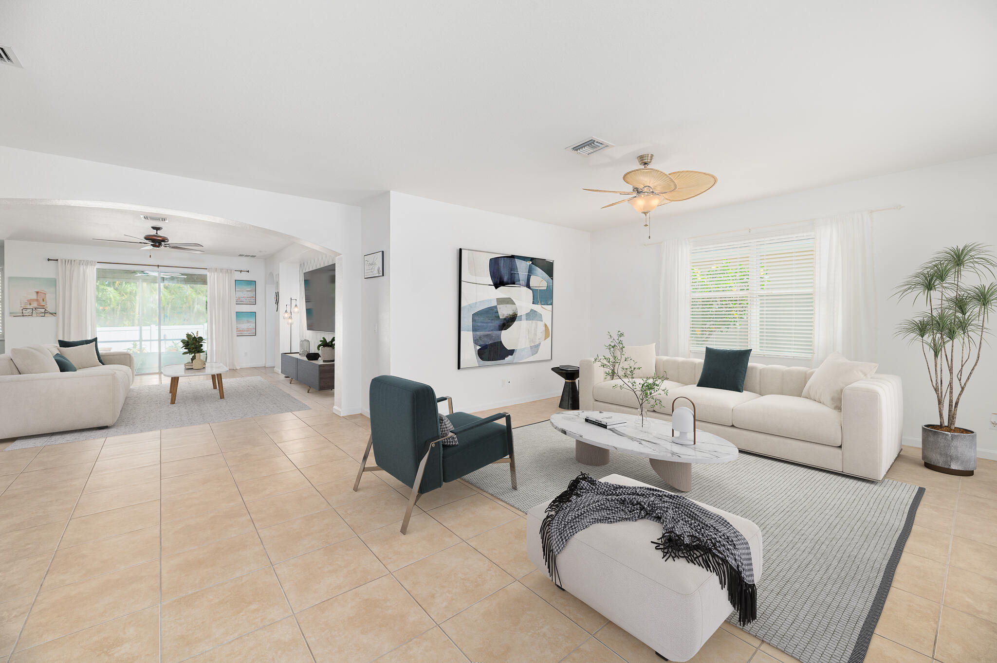 2187 Northwest Dalea Way Stuart, FL 34994 - Photo 7 of 41 a living room with furniture a couch and a chandelier