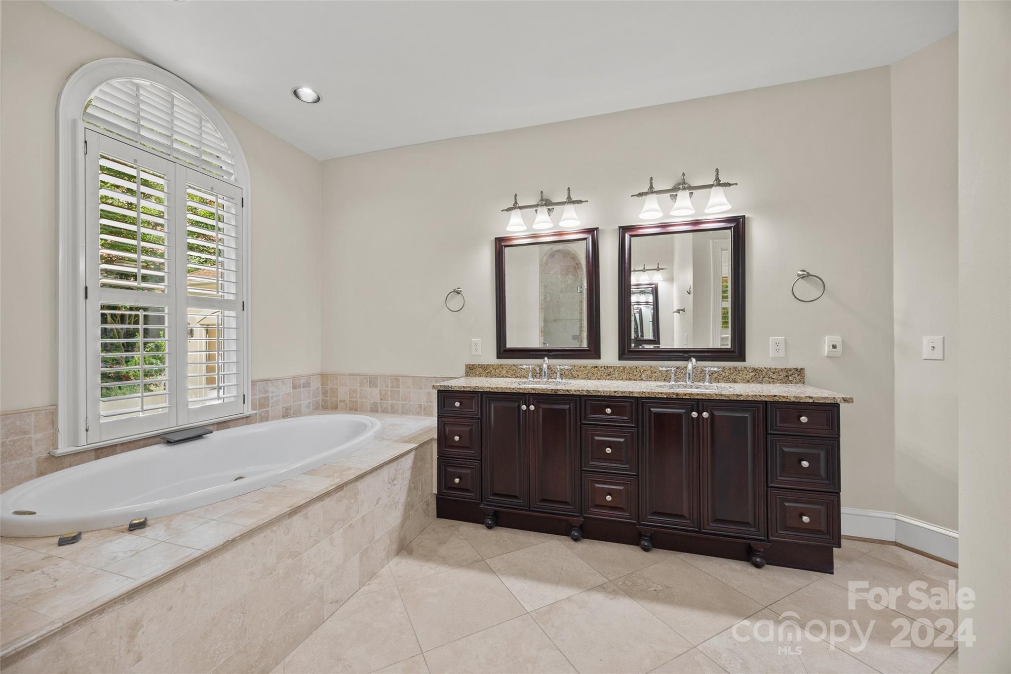 16201 Crest Cove Road Charlotte, NC 28278 - Photo 16 of 48 a spacious bathroom with a tub sink and mirror
