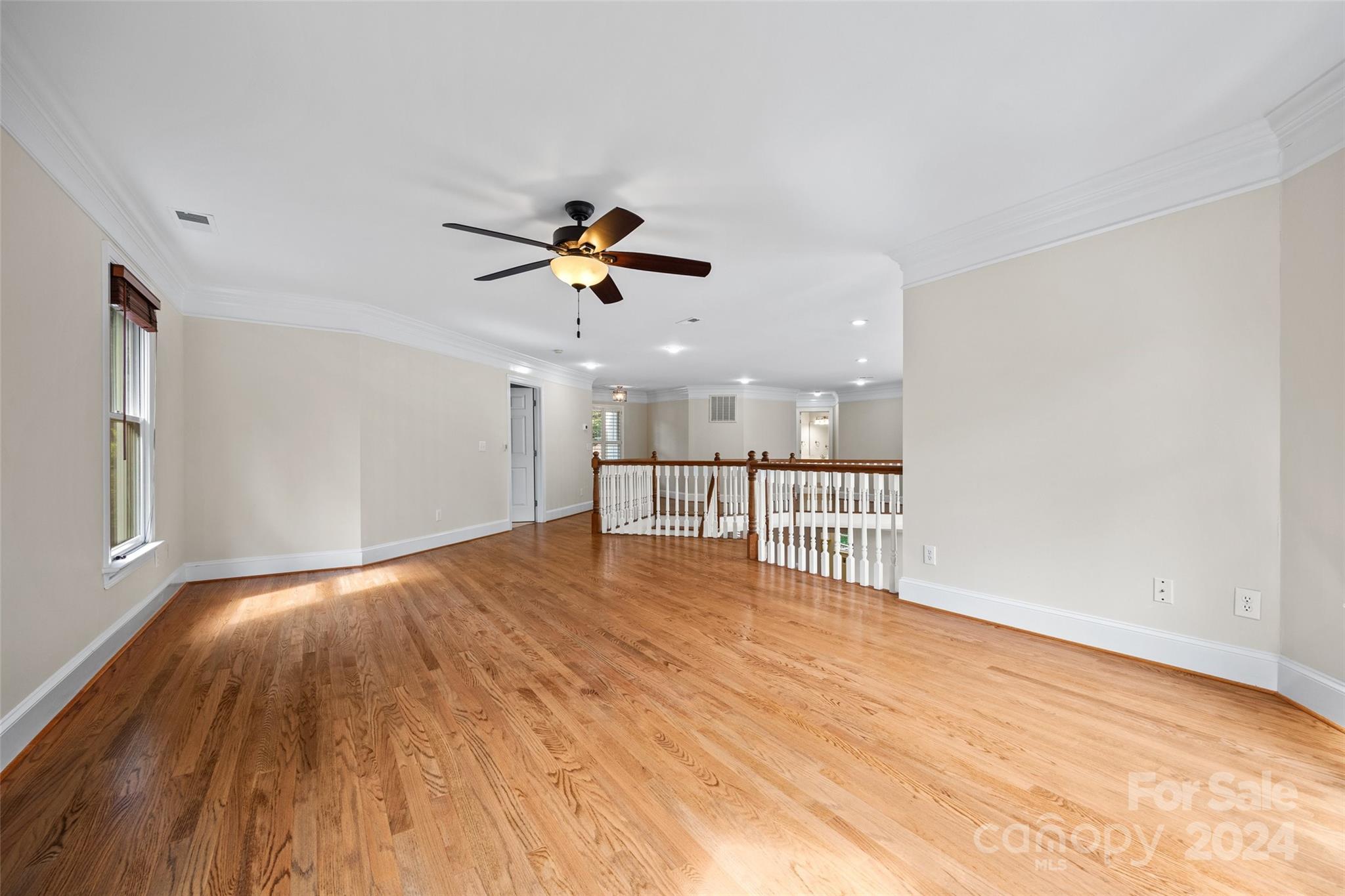 16201 Crest Cove Road Charlotte, NC 28278 - Photo 20 of 48 a view of empty room with wooden floor and fan