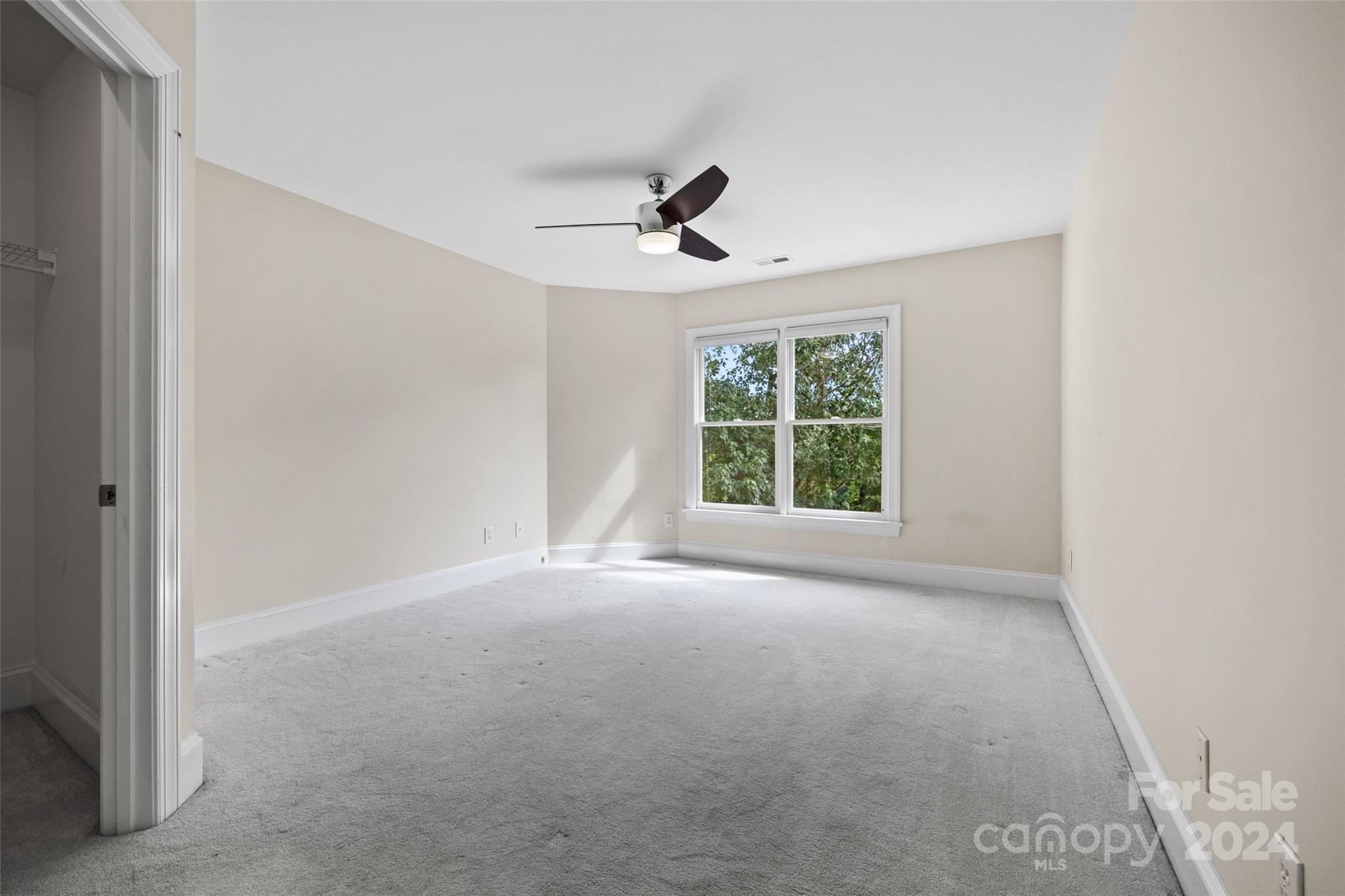 16201 Crest Cove Road Charlotte, NC 28278 - Photo 22 of 48 an empty room with windows and ceiling fan