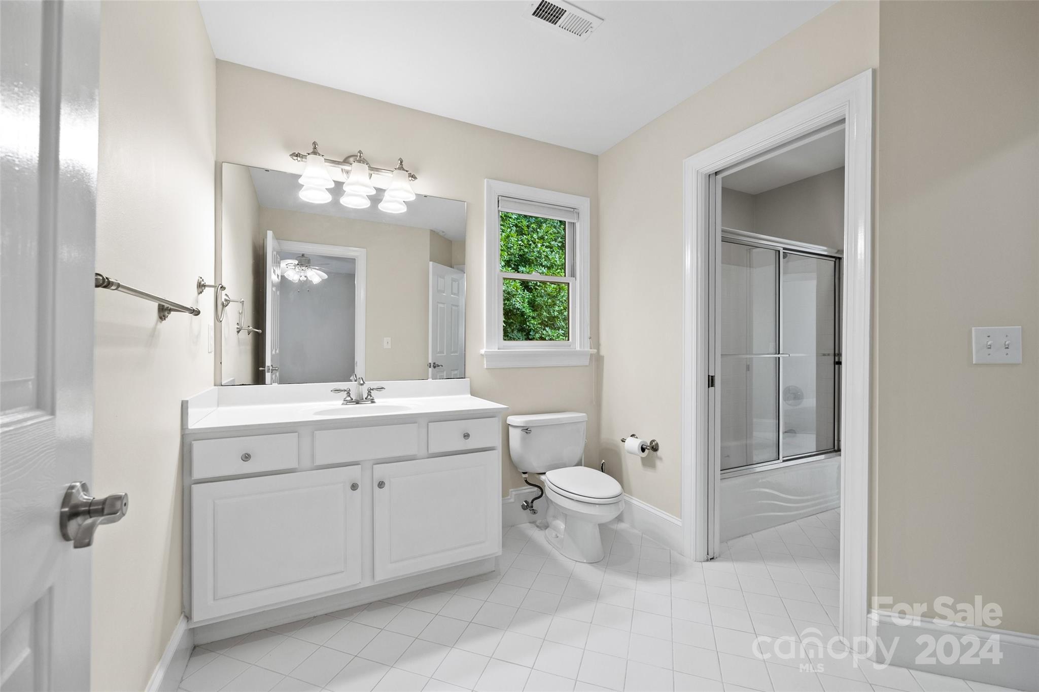 16201 Crest Cove Road Charlotte, NC 28278 - Photo 24 of 48 a bathroom with a double vanity sink a toilet and a mirror