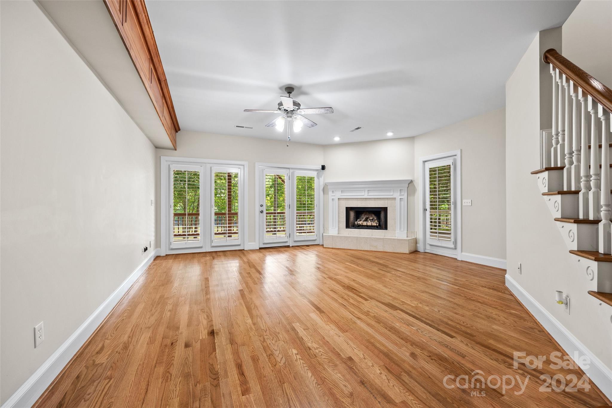 16201 Crest Cove Road Charlotte, NC 28278 - Photo 27 of 48 a view of an empty room with wooden floor fireplace and a window