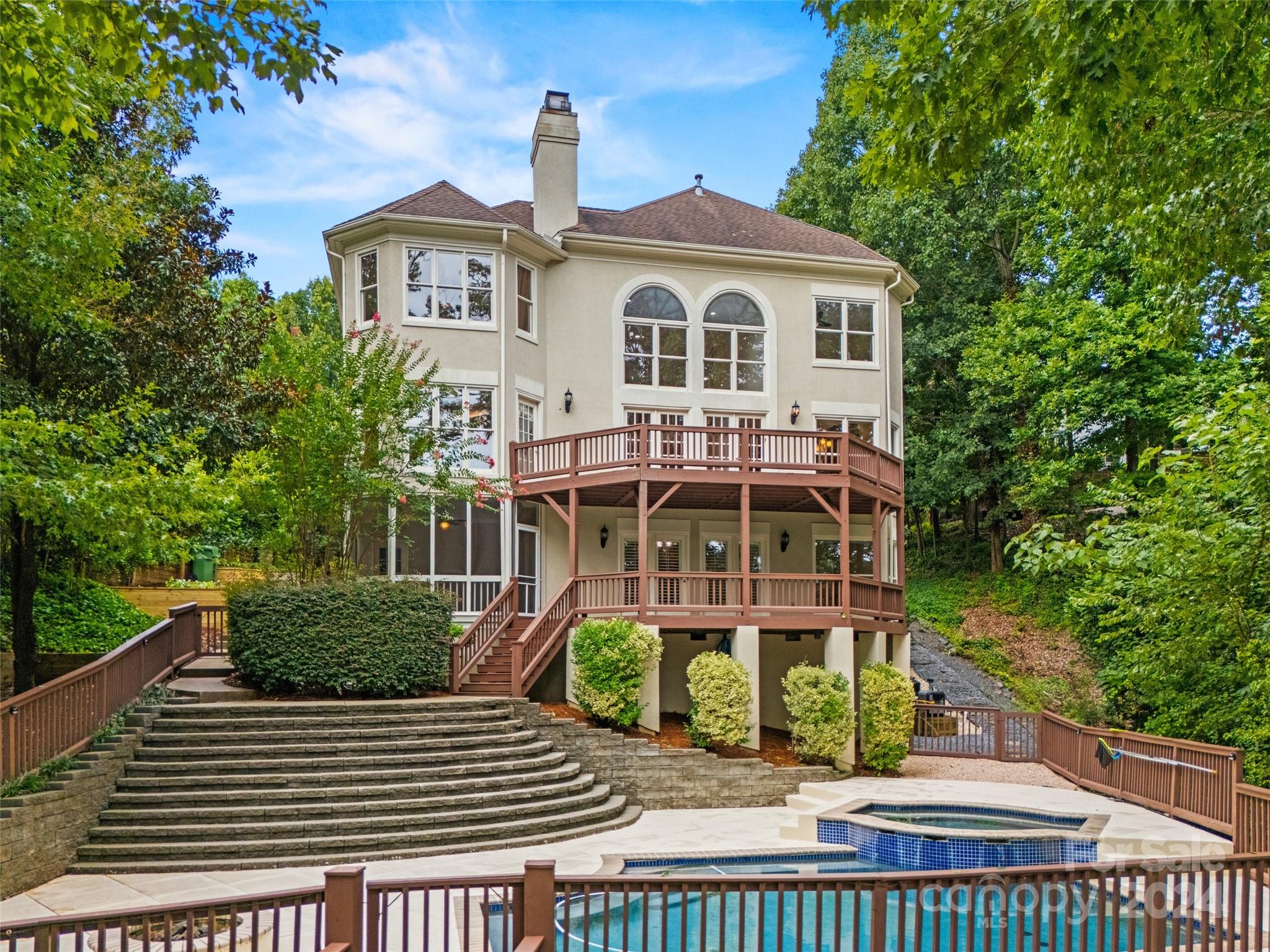 16201 Crest Cove Road Charlotte, NC 28278 - Photo 40 of 48 a view of a brick house with large windows and a table and chairs