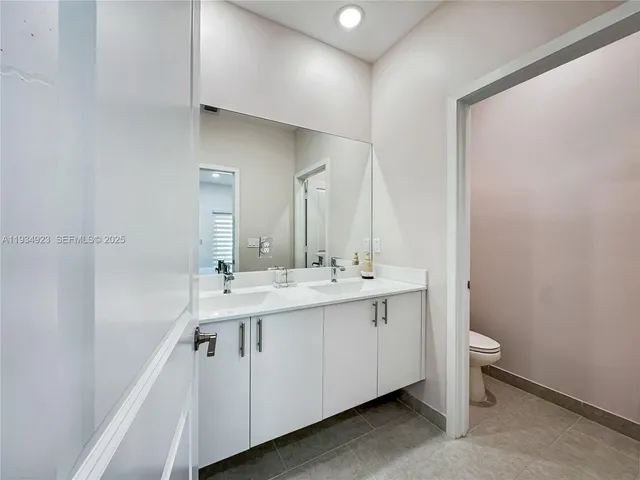 a bathroom with a double vanity sink and a mirror