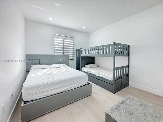 a spacious bedroom with a bed and a window