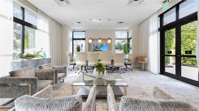 a view of a dining room with furniture large windows and wooden floor