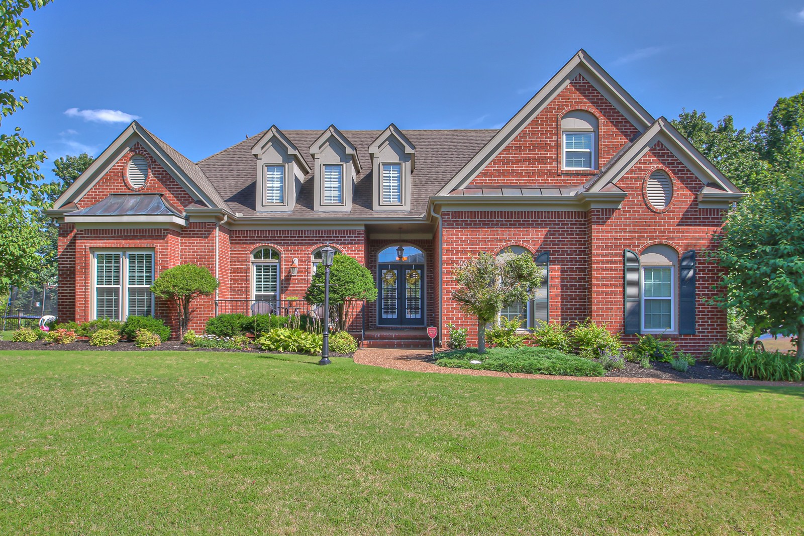 a front view of a house with garden