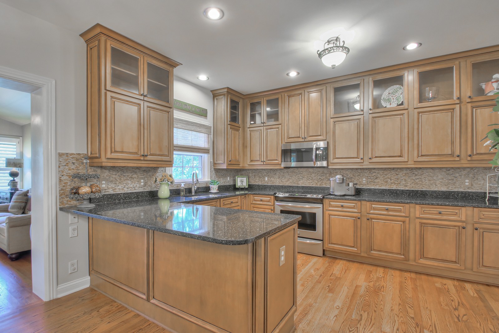 244 Chester Stevens Road Franklin, TN 37067 - Photo 11 of 56 a kitchen with stainless steel appliances granite countertop a stove top oven a sink dishwasher and cabinets with wooden floor