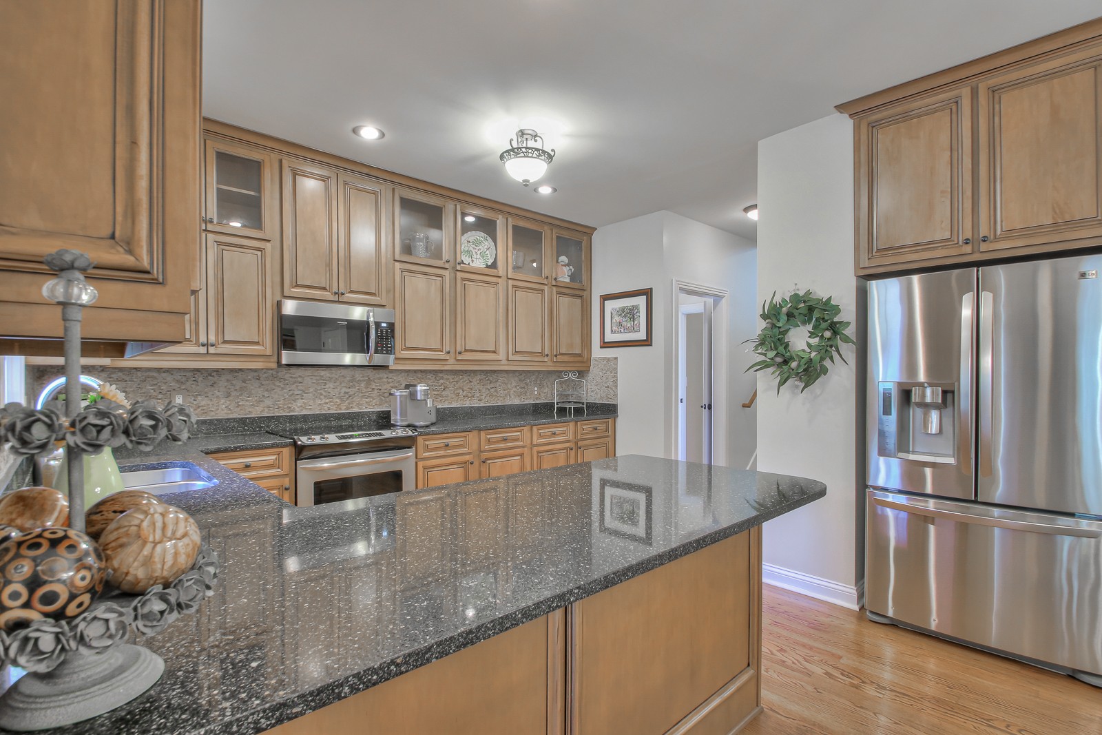 244 Chester Stevens Road Franklin, TN 37067 - Photo 16 of 56 a kitchen with stainless steel appliances granite countertop a refrigerator a stove and a sink with wooden floors