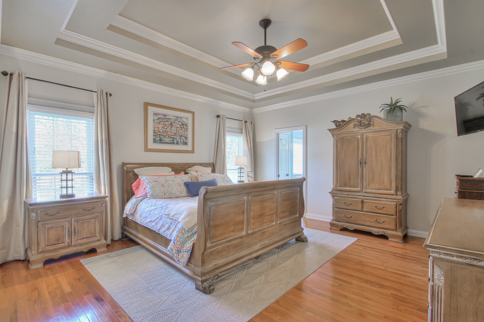 244 Chester Stevens Road Franklin, TN 37067 - Photo 19 of 56 a spacious bedroom with a bed and a chandelier