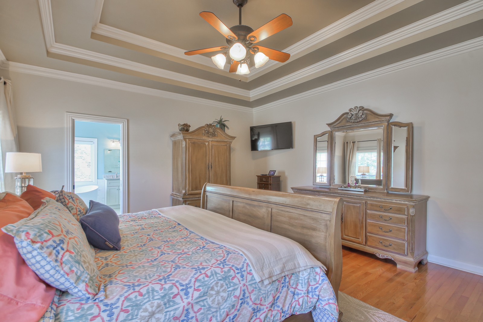 244 Chester Stevens Road Franklin, TN 37067 - Photo 20 of 56 a bedroom with a bed a chandelier and mirror on dresser