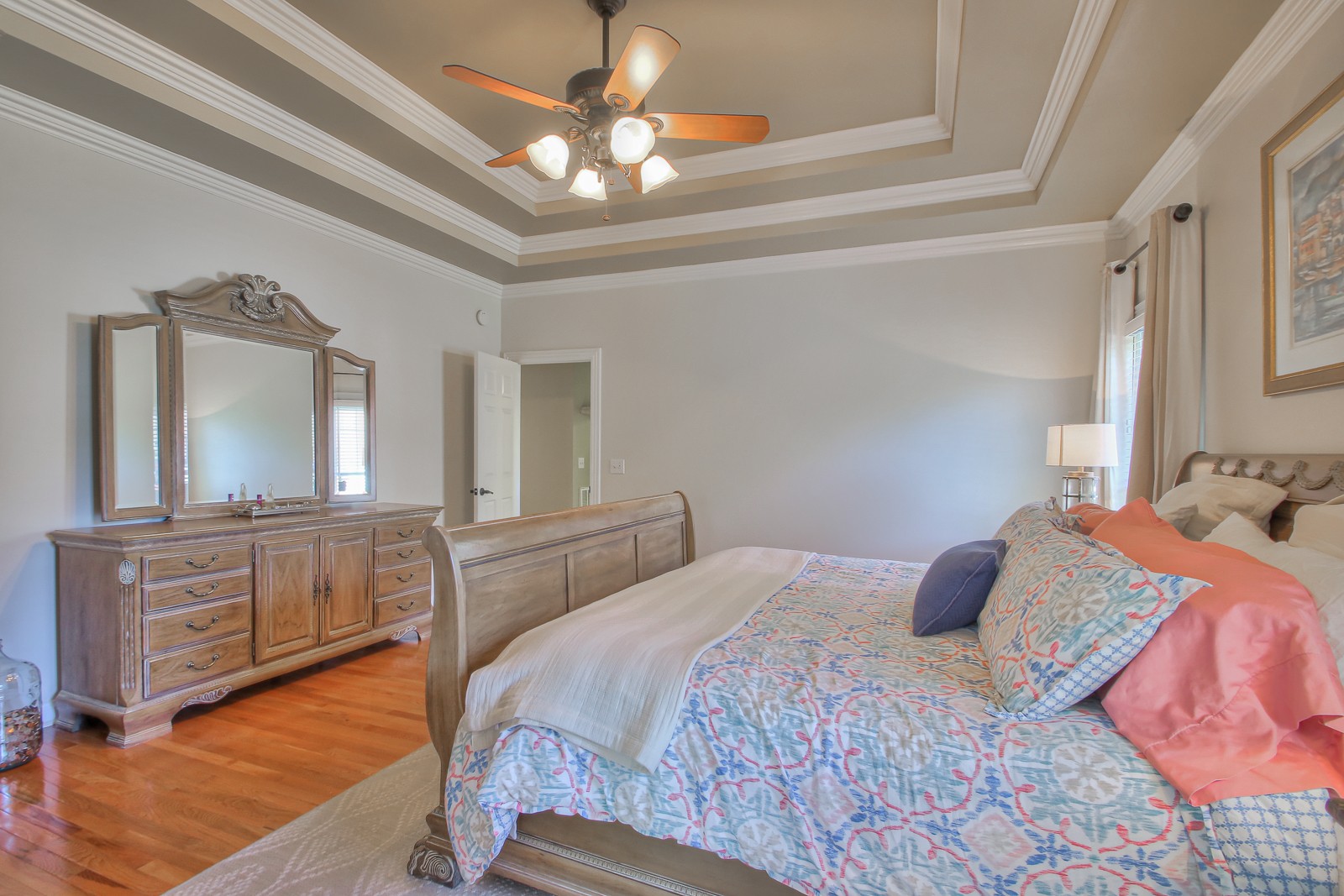 244 Chester Stevens Road Franklin, TN 37067 - Photo 21 of 56 a bedroom with a large bed a chandelier with dresser and mirror