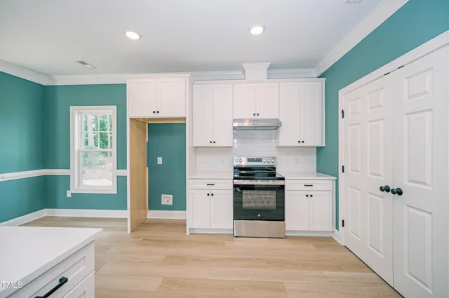 a kitchen with granite countertop a refrigerator and a sink