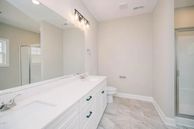 a spacious bathroom with a granite countertop sink and a mirror