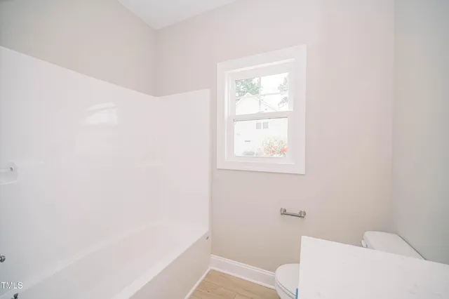 a bathroom with a toilet and a bathtub