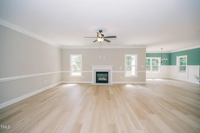 wooden floor in an empty room with a fireplace