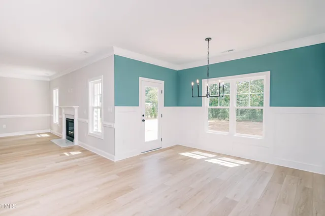 a view of a house with a wooden fence