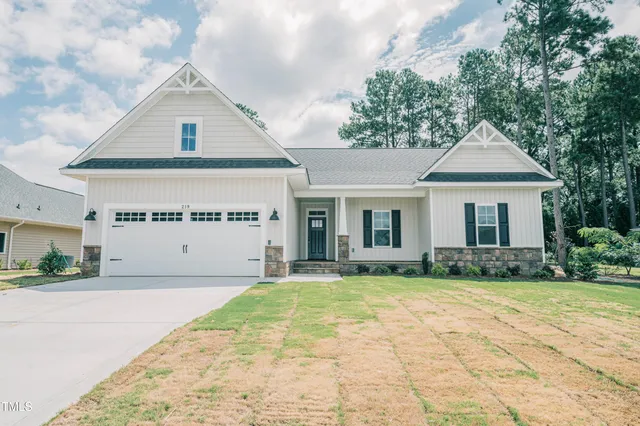 a house that has a big yard with large trees