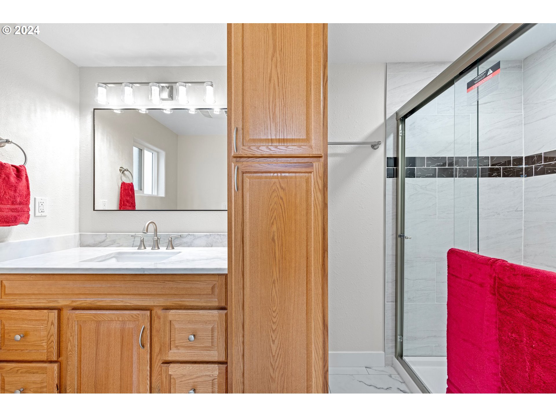 1356 D Street Springfield, OR 97477 - Photo 12 of 45 a bathroom with a sink a mirror and a shower