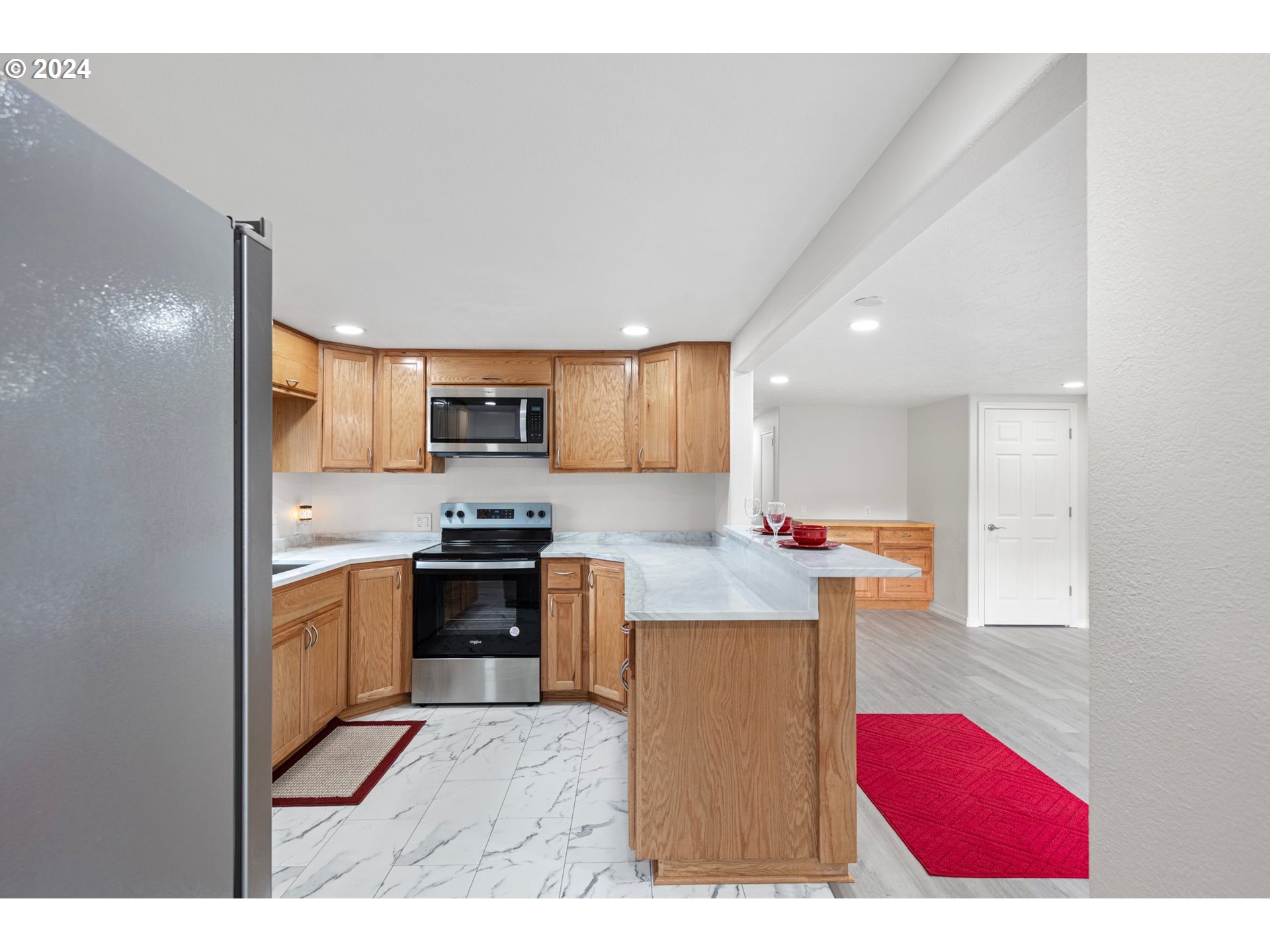 1356 D Street Springfield, OR 97477 - Photo 14 of 45 a kitchen with stainless steel appliances kitchen island granite countertop a stove a sink and a microwave