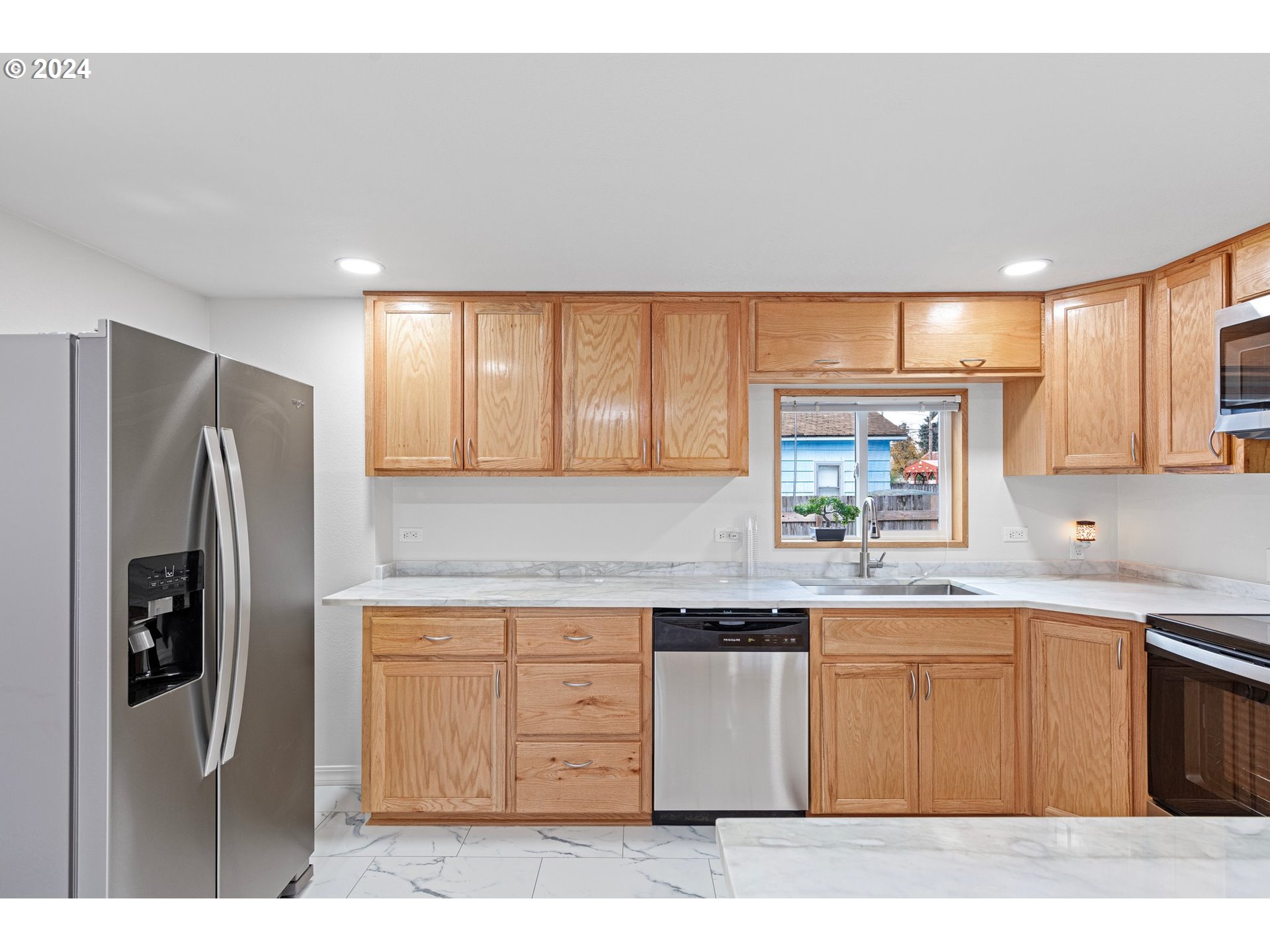 1356 D Street Springfield, OR 97477 - Photo 16 of 45 a kitchen with a sink a refrigerator and cabinets