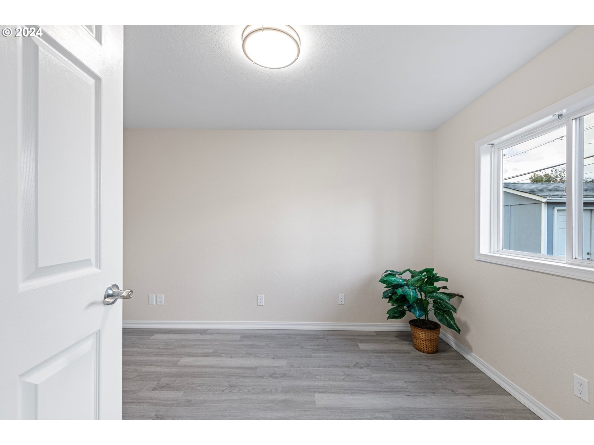 1356 D Street Springfield, OR 97477 - Photo 29 of 45 a view of an empty room with wooden floor and a window