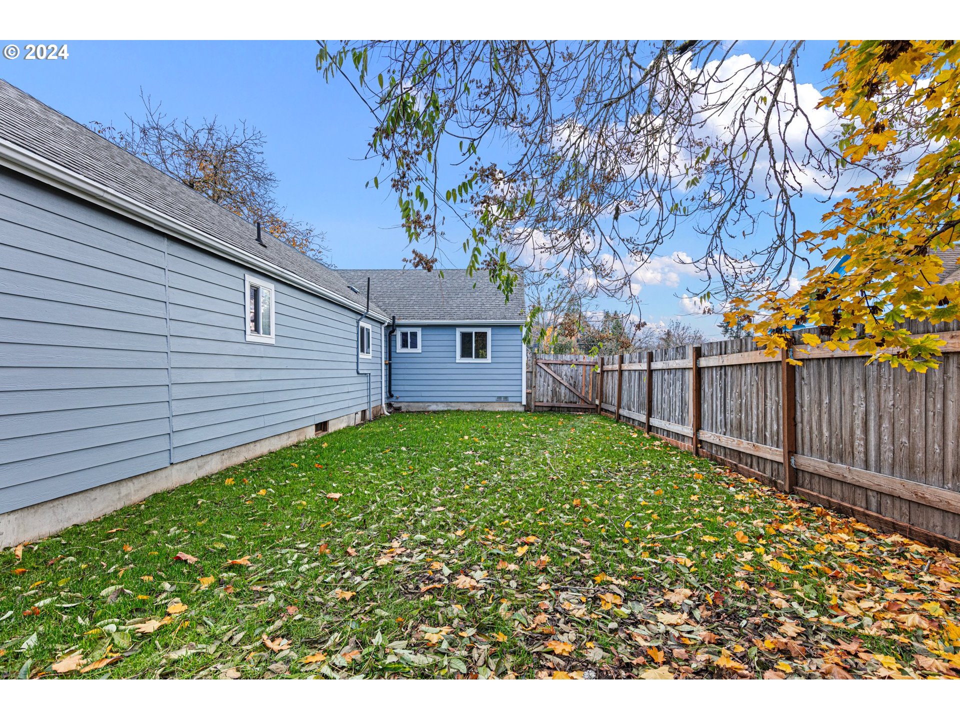 1356 D Street Springfield, OR 97477 - Photo 42 of 45 a view of a backyard with plants and wooden fence