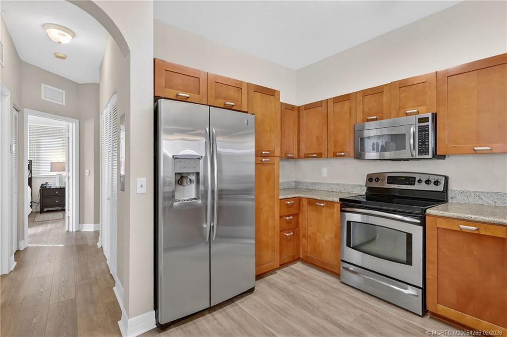 61 Southeast Palermo, Unit 204 Stuart, FL 34994 - Photo 6 of 32 Have it all in this kitchen with granite and stainless appliances.