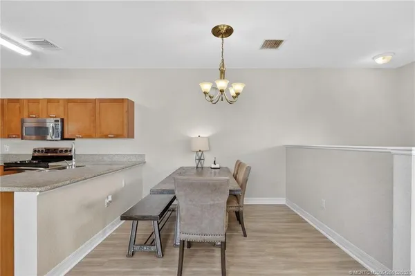 a dining room with furniture and chandelier