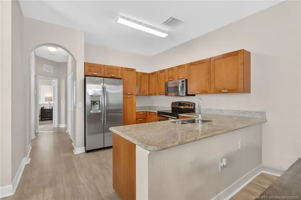 a view of a dining room with furniture wooden floor and chandelier