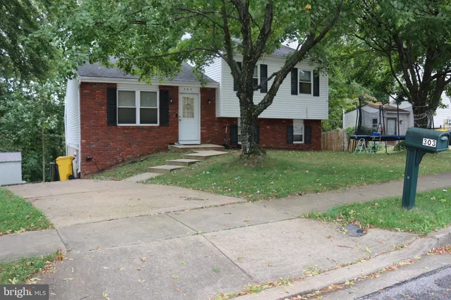 a front view of a house with a yard and a garage