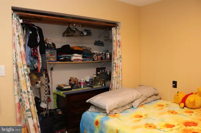 a bedroom with a bed and a closet